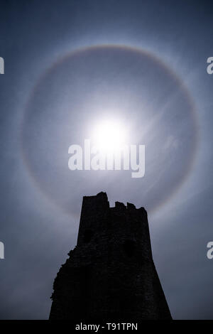 Aberystwyth Wales UK, Thursday 16 May 2019  UK Weather: A perfect circular sun halo , formed as the rays of the sun shine through ice crystals in the upper atmosphere, seen in the sky above  the ruins of Aberystwyth castle. The halos, always at 22º from the sun,  often  indicate that rain will fall within the next 24 hours, since the cirrostratus clouds that cause them can signify an approaching frontal system. The  weather is set to change overnight from the fine warm conditions to cooler and wetter days, more typical of mid May.  photo credit Keith Morris / Alamy Live News Stock Photo