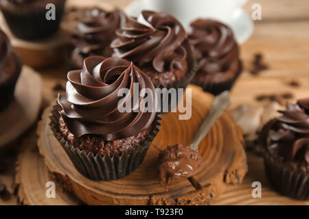 Delicious chocolate cupcakes on wooden board Stock Photo