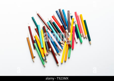 Multicoloured pencils scattered on a white background Stock Photo