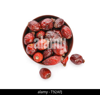 Bowl with rose hips on white background Stock Photo