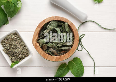 Composition with dried mint on white wooden background, top view Stock Photo