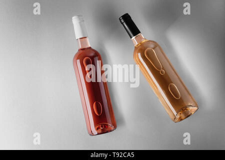 Bottles with different kinds of wine on grey background Stock Photo