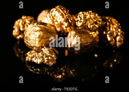 Golden walnuts on black background Stock Photo