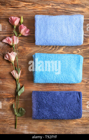 Clean soft towels on wooden background, top view Stock Photo