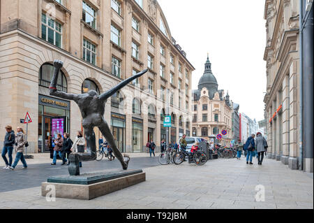 Pedestrians on street alongside with old buildings in central business district and city square near Augustusplatz in downtown Leipzig, Germany Stock Photo