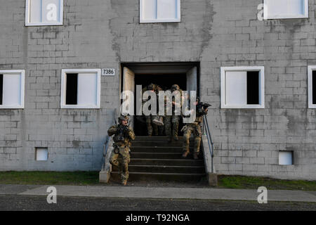 U.S. Air Force Special Tactics Airmen with the 125th Special Tactics Squadron, Portland Air National Guard, depart a building with simulated patients during an exercise in Portland, Oregon, Nov. 5, 2018. Special Tactics teams conduct personnel recovery missions, from rapid mission planning to technical rescue, treatment and exfiltration. (U.S. Air Force photo by Staff Sgt. Rose Gudex) Stock Photo