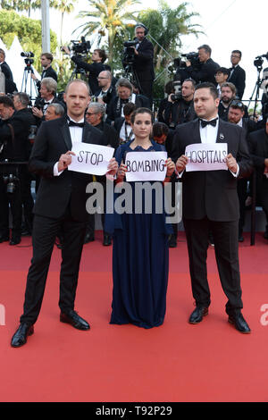 May 15, 2019 - Cannes, France - CANNES, FRANCE - MAY 15: Guests display placards reading ''Stop Bombing Hospitals'' as they arrive for the screening of the film ''Les Miserables'' at the 72nd edition of the Cannes Film Festival in Cannes, southern France, on May 15, 2019. (Credit Image: © Frederick InjimbertZUMA Wire) Stock Photo