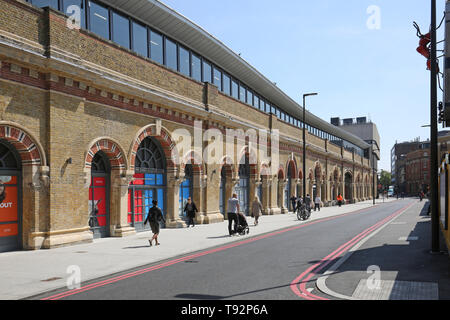Newly refurbished retail units in ornate arches beneath London Bridge Station, on St Thomas Street, London, UK Stock Photo