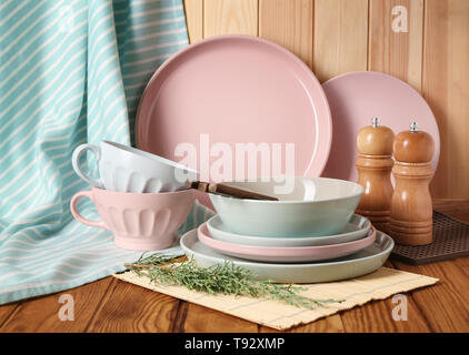 Set of clean dishware on wooden table Stock Photo