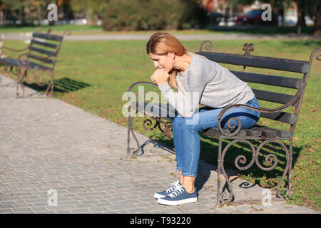 Woman having panic attack outdoors Stock Photo