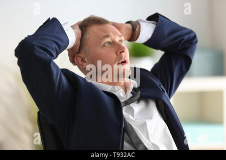Man having panic attack at workplace in office Stock Photo