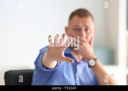 Man having panic attack at workplace in office Stock Photo