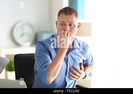 Man having panic attack at workplace in office Stock Photo