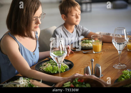 Family praying before meal at home Stock Photo