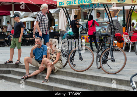 LINZ, AUSTRIA - AUGUST 02, 2018:  Tourists relax in the central city square. Stock Photo