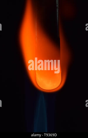 Copper oxide being reduced by magnesium turnings Stock Photo