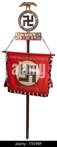 An SA 'Salzkammergut' banner Banner cloth of red silk with black/white/red fringes on the outer and lower edges, and tassels in black, white and red. At the top, a pocket to insert the mounting pole. On both sides a white disc with a horizontal swastika in black, offset with silver braiding, the motto 'Deutschland Erwache' (tr. 'Germany Awake') embroidered in white on the front, and 'Nat. Soz. Deutsche Arbeiterpartei' and 'Sturmabteilung' (tr. 'Storm Battalion') on the back. Dimensions circa 70 x 70 cm. The banner finial silver-plated and gilded, the soldered swastika in th, Editorial-Use-Only Stock Photo