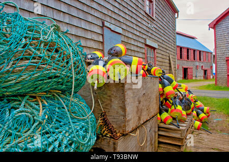 Fishing buoys and piles of rope beside a fsihing shed in Seal Cove, Grand Manan Island, New Brunswick, Canada Stock Photo