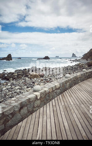 Wooden boardwalk by the Roque de Las Bodegas Beach, retro color toning applied, Tenerife, Spain. Stock Photo