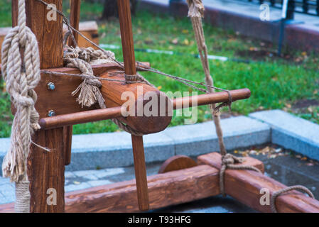 ancient catapult on the ramparts of Alghero ,Sardinia Island, Italy , Defensive wall. Catapult in the downtown of the citywith the sea as background a Stock Photo