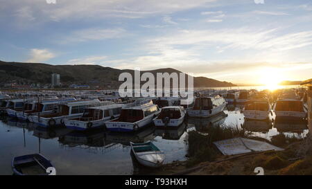 Sunrise over Lake Titicaca with boats. Puno, Peru. Stock Photo