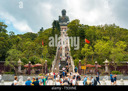Hong Kong, China - People climbing up to the Big Buddha statue Stock Photo