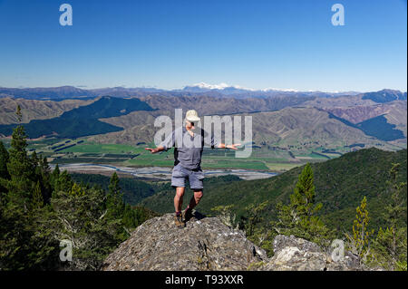 Dance on a hill top and show the world you're enjoying life, an older man is dancing on a rocky outcrop. Stock Photo