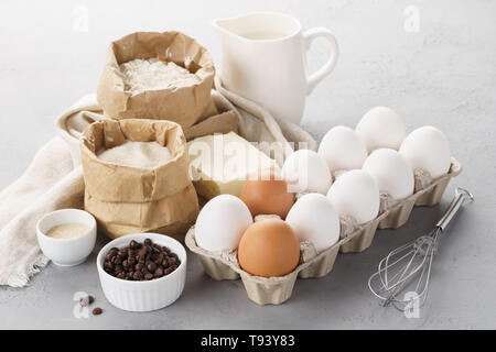 Various baking ingredients for sweet pastry. Dough recipe. Milk, flour, eggs, sugar and butter Stock Photo