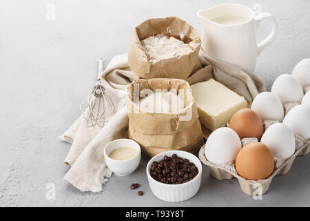 Various baking ingredients for sweet pastry. Dough recipe. Milk, flour, eggs, sugar and butter Stock Photo