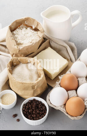 Various baking ingredients for sweet pastry. Dough recipe. Milk, flour, eggs, sugar and butter Stock Photo