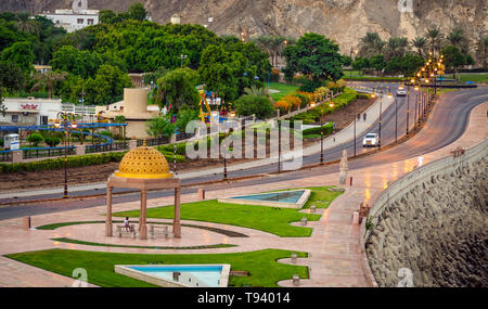 Well built seaside walk in Muttrah, Muscat, Oman with a Golden Gazebo Dome. With golden sunlight at dawn. Stock Photo