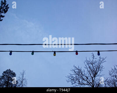 garland of the switched-off multi-colored bulbs against the cloudy sky , Moscow Stock Photo