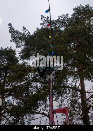 garland of the switched-off multi-colored bulbs against the cloudy sky , Moscow Stock Photo