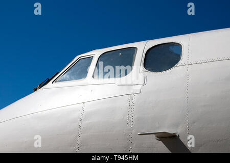 Fuselage cockpit. Part of the aircraft. The nose of the aircraft against the blue sky. Stock Photo