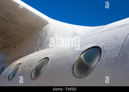 Fuselage cabin. Part of the aircraft. The body of the aircraft against the blue sky. Stock Photo