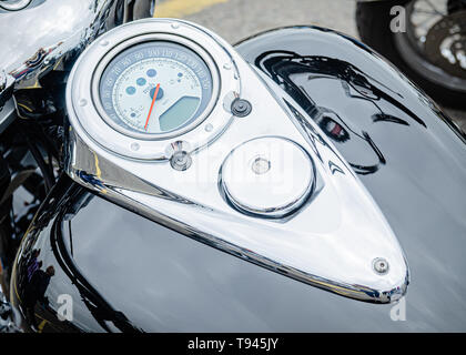 The instrument panel for a highly-polished, well presented, motorcycle is mounted centrally atop of the motorcycle’s petrol tank. Stock Photo
