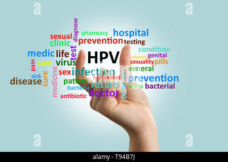 Woman doctor showing with fingers hpv word on invisible glass screen as informing concept closeup Stock Photo