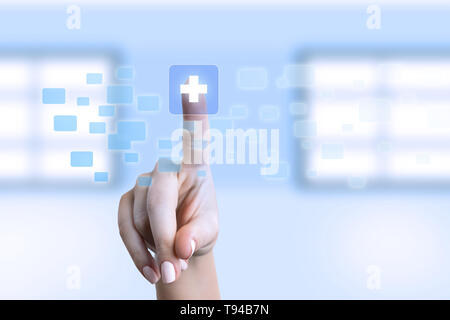 Female nurse touching plus symbol on transparent screen as futuristic medicine concept Stock Photo