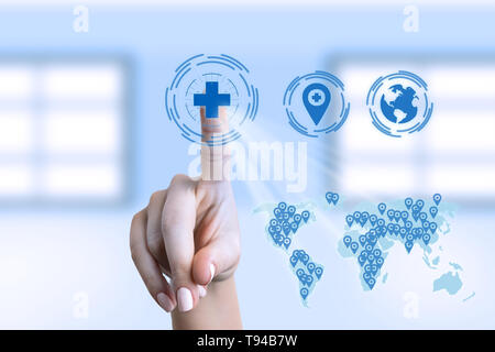 Woman medic touching medical cross symbol on invisible display with world map Stock Photo
