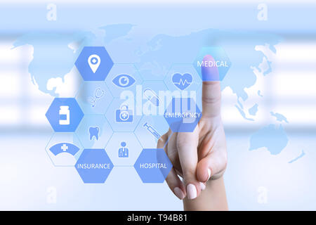 Nurse woman pressing medical button on screen with symbols and world map as background Stock Photo