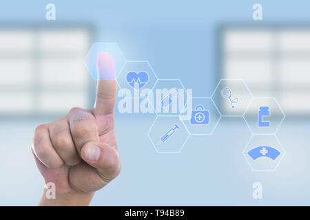 Male doctor touching empty button with index finger on transparent display as modern technology concept Stock Photo