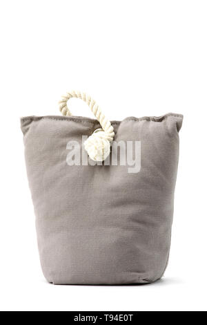 Vintage door stopper made of gray cloth with filling and handle rope Stock Photo