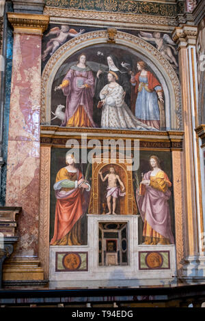 Italy: inside San Maurizio al Monastero Maggiore, a church known as the Sistine Chapel of Milan, altarpiece and partition wall in the faithful's area Stock Photo