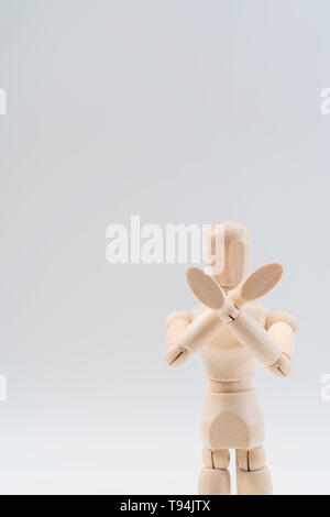 Refusal gesture, Wooden dummy, crossed hands on white background, copy space for your object or text Stock Photo
