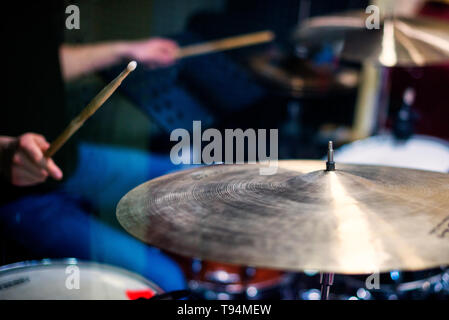 Professional drum set closeup. Man drummer with drumsticks playing drums and cymbals Stock Photo