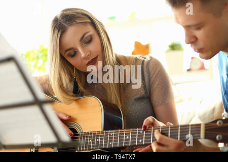 Music Playing Lesson Lovers Couple at Living Room Stock Photo