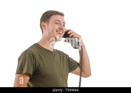 Photo of a man who is speaking at an old phone, isolated on white background Stock Photo