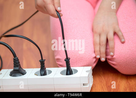 Little child playing with plug Stock Photo