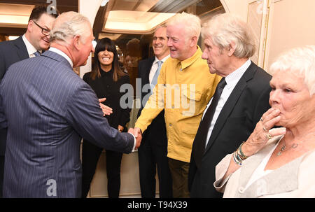 The Prince of Wales shakes hands with Chris Evans, watched by Claudia Winkleman (centre) and Dame Judi Dench and her partner David Mills at the annual Fortnum & Mason Food and Drink Awards at Fortnum & Mason, central London. Stock Photo