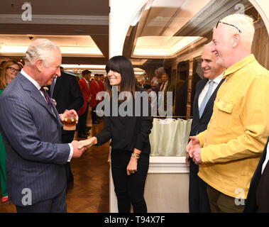 The Prince of Wales shakes hands with Claudia Winkleman watched by Chris Evans (right), at the annual Fortnum & Mason Food and Drink Awards at Fortnum & Mason, central London. Stock Photo